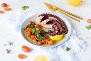 Octopus in olive oil with garlic, parsley and tomatoes