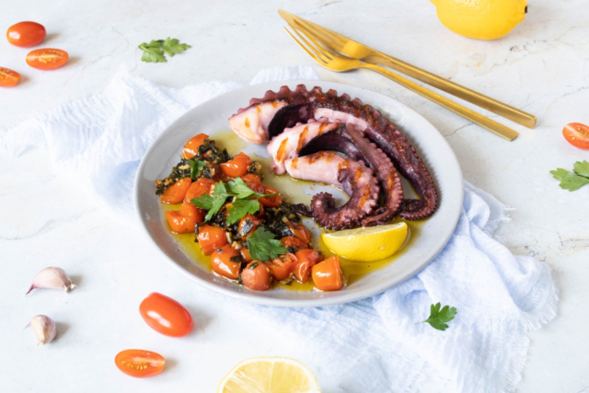 Octopus in olive oil with garlic, parsley and tomatoes