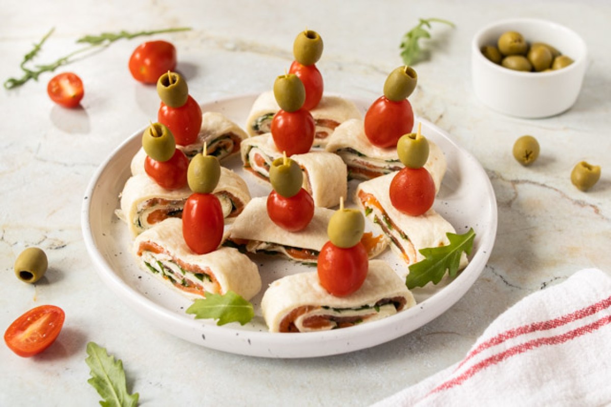 Rolled tortilla with cream cheese, smoked salmon, and arugula