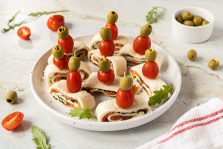 Rolled tortilla with cream cheese, smoked salmon, and arugula