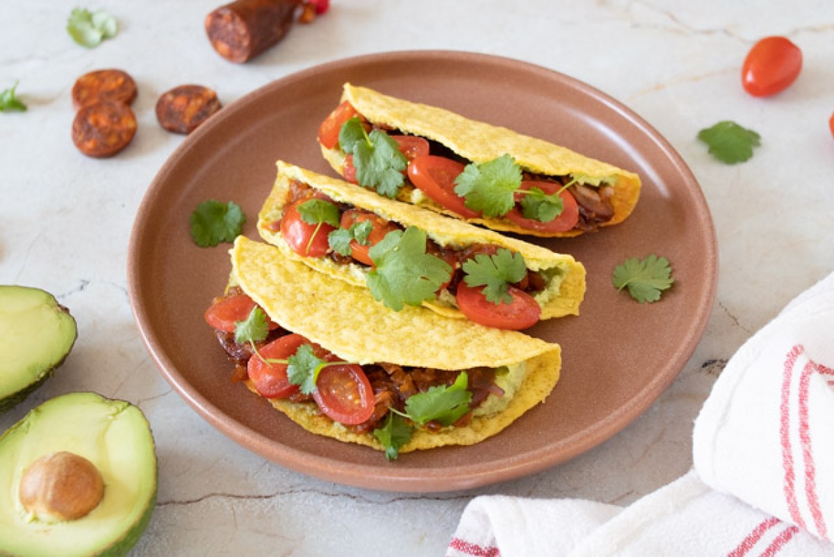 Taco with chorizo and avocado salsa