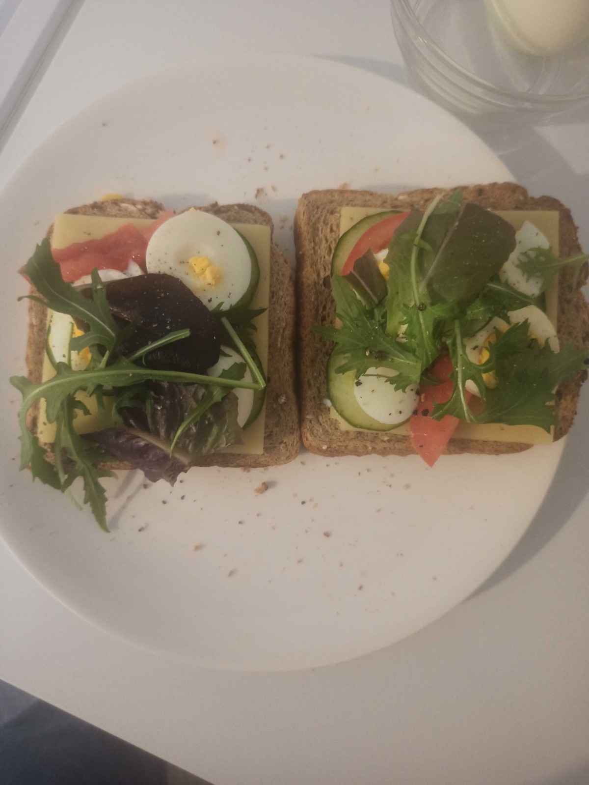 Wheat bread slices with tomato cheese eggs cucumber and salad