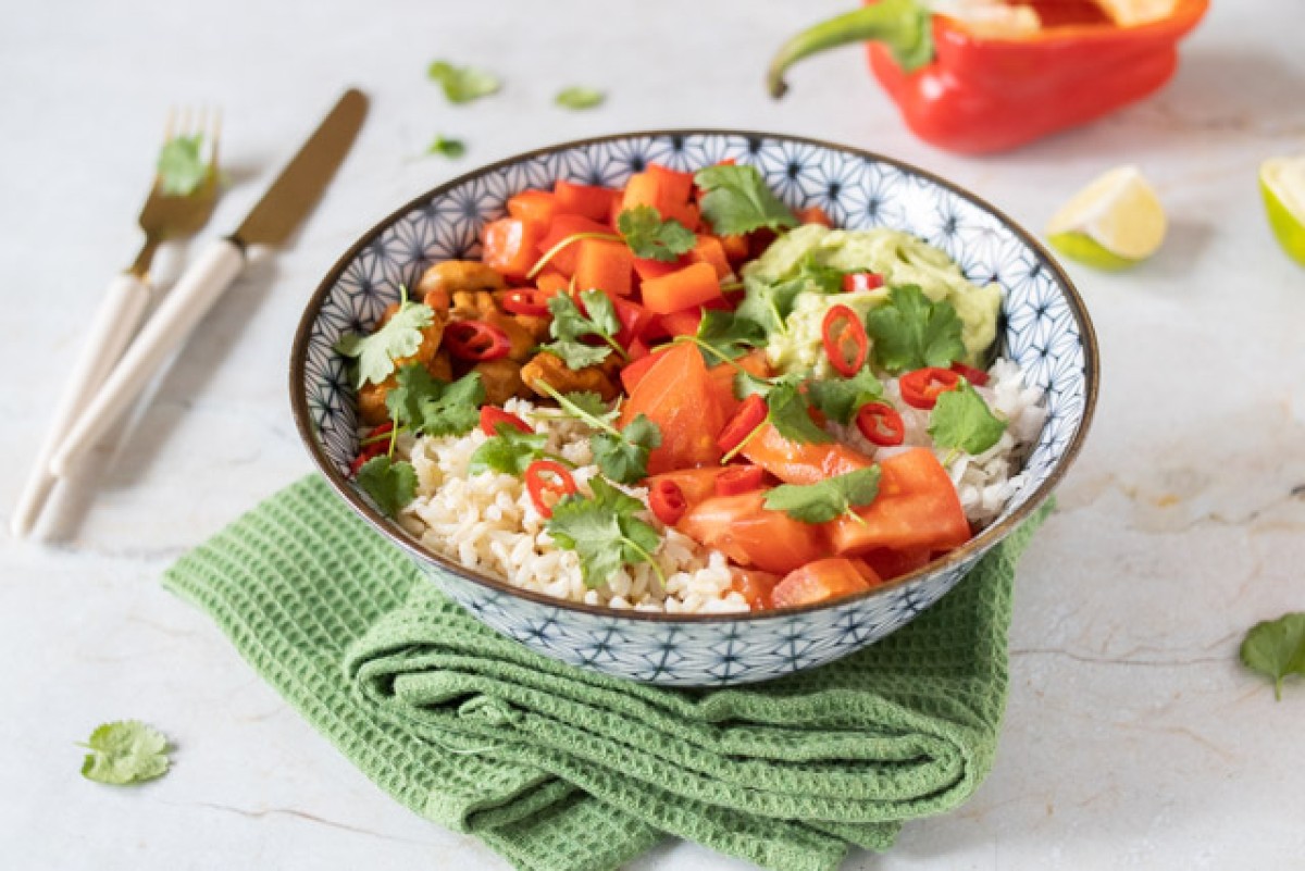 Bowl with rice, Mexican-style chicken, vegetables, and avocado paste