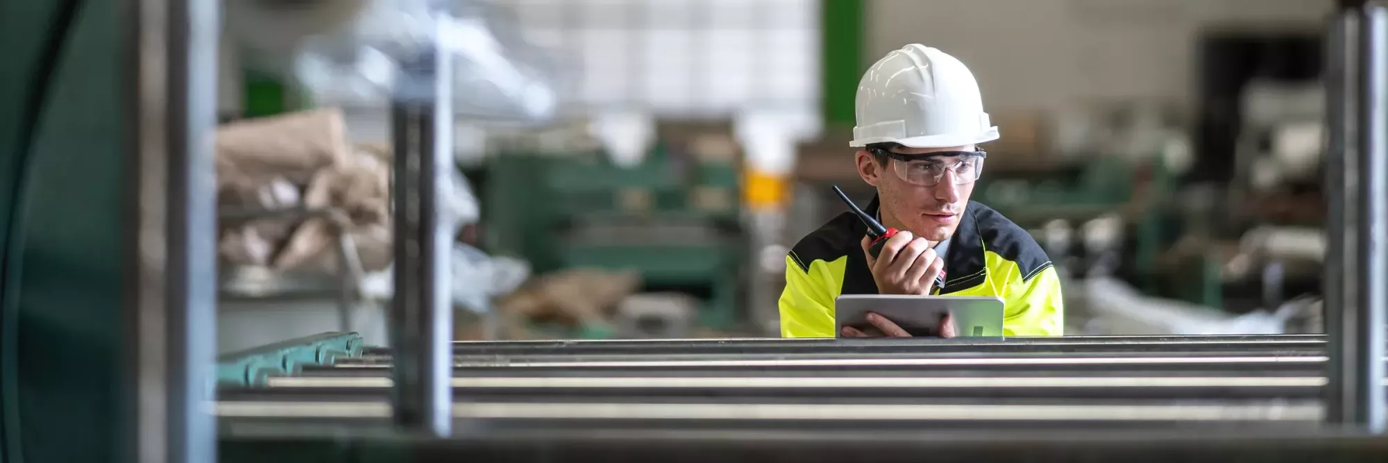 16x9-employee-with-hard-hat-speaking-into-walkie-talkie-GET-1405928496.2400