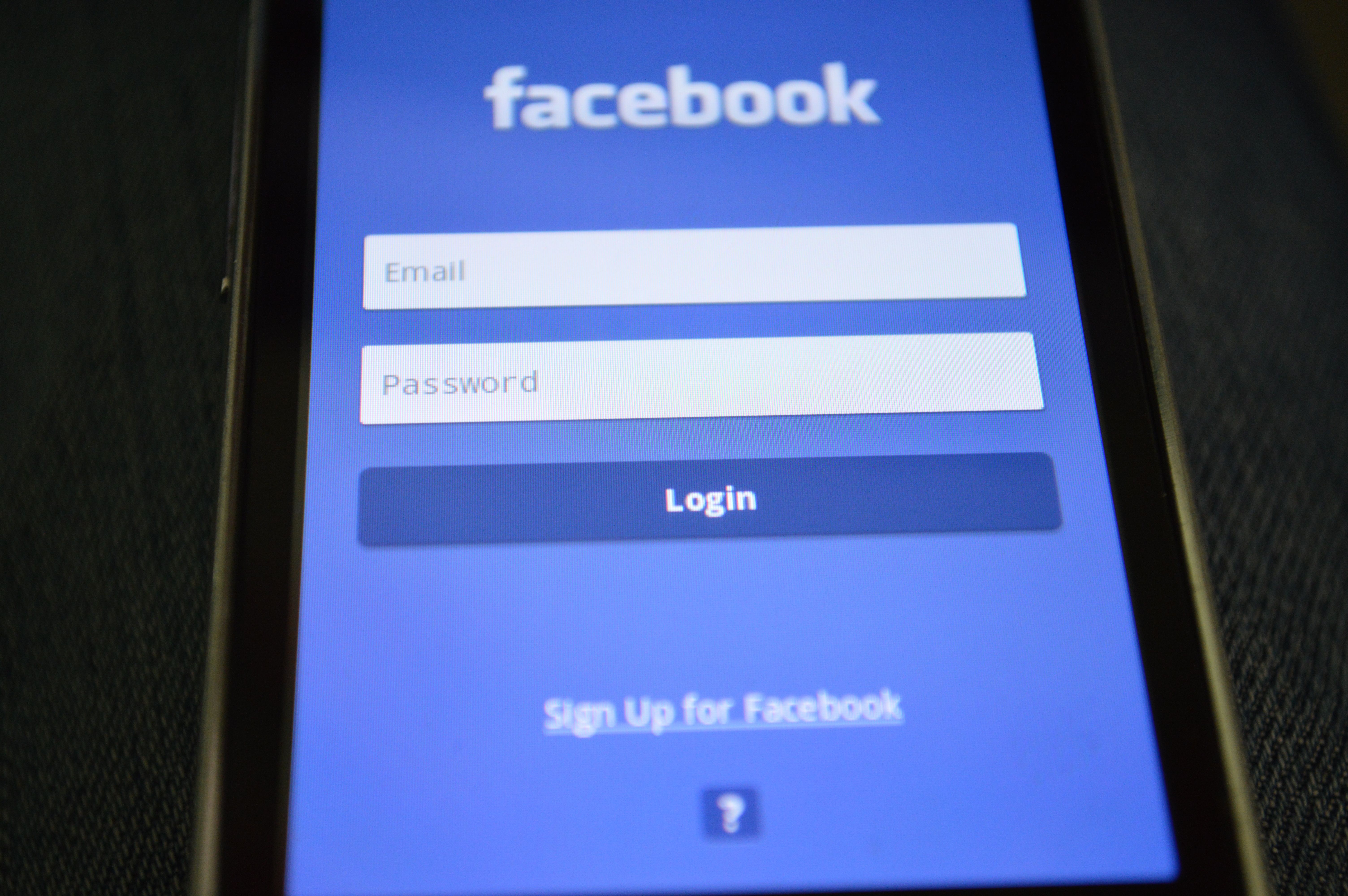 Mobile phone with Facebook login screen, highlighting digital connectivity and social media use.