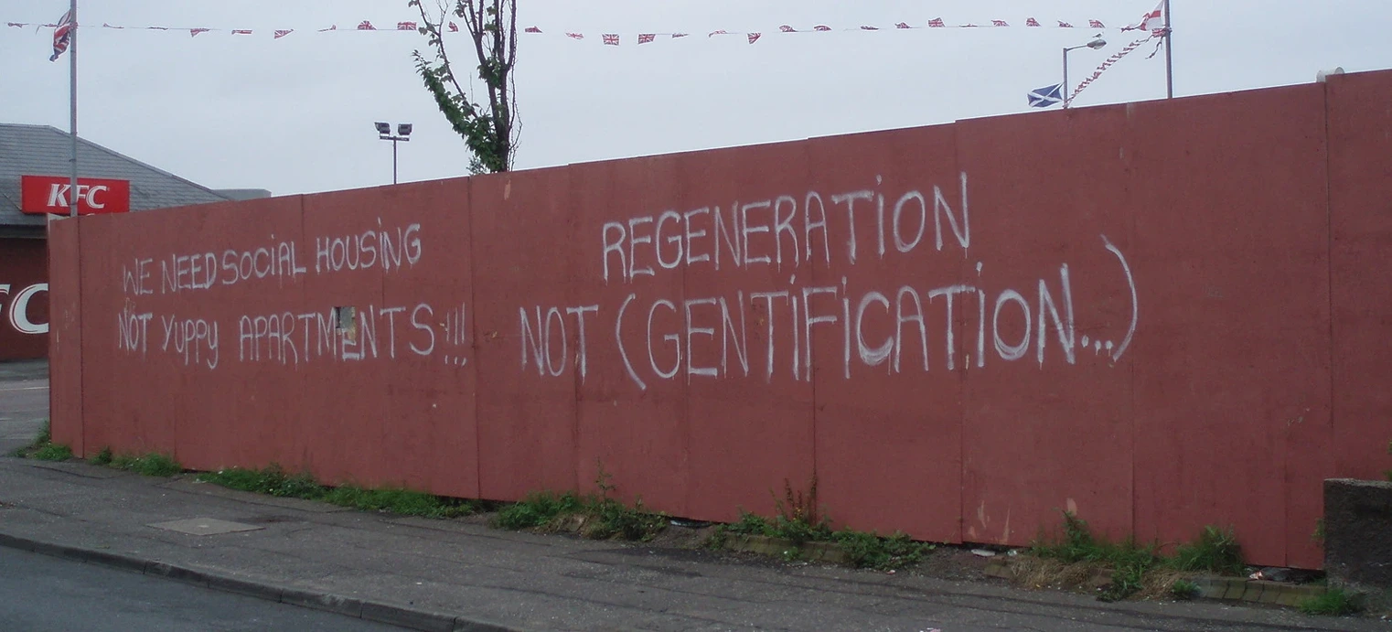 Regeneration, Writing on the wall that reads regeneration not gentrification, StudySmarter