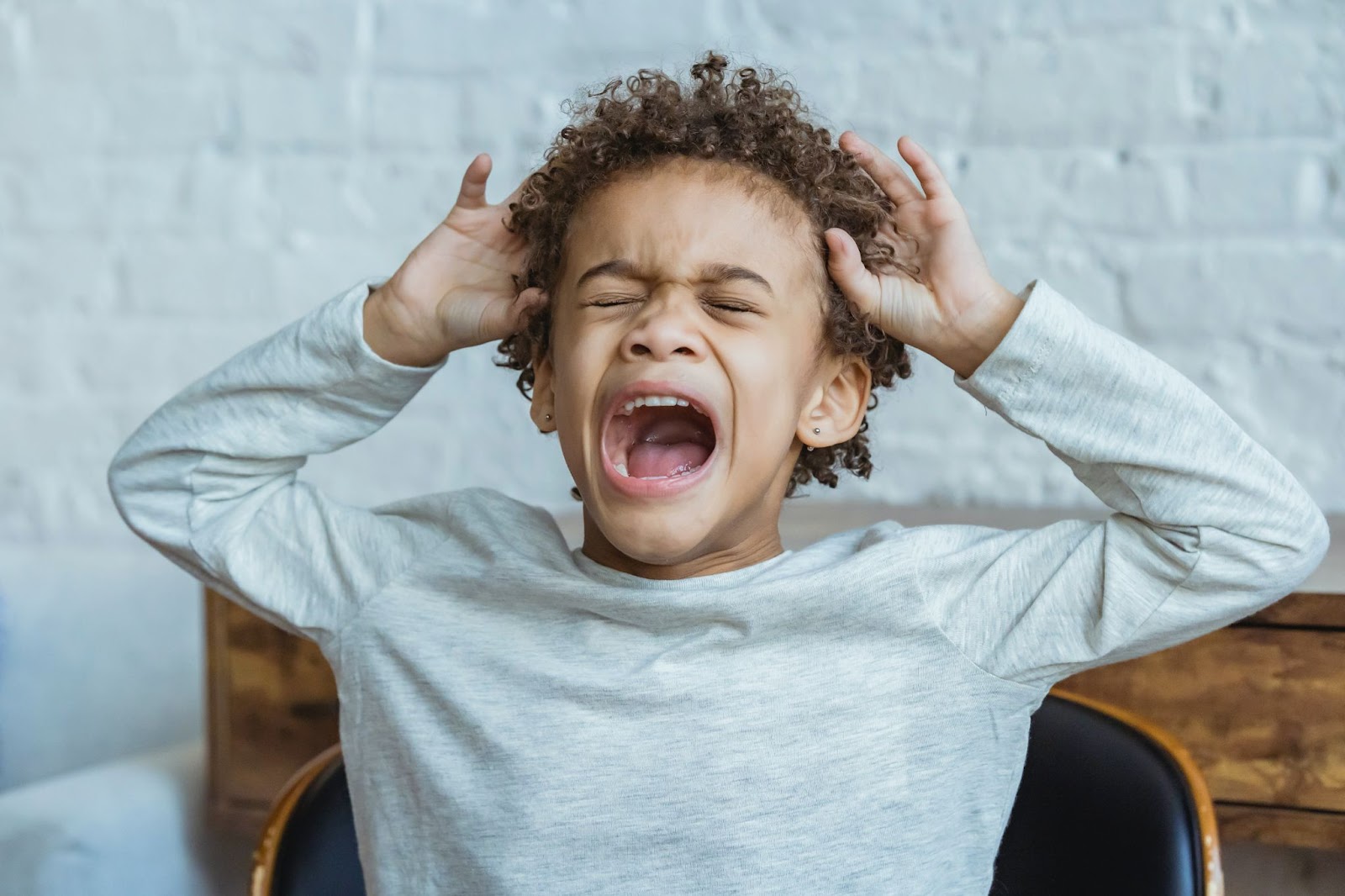 Sensory Processing Disorders, child crying in response to sensory overwhelm, StudySmarter