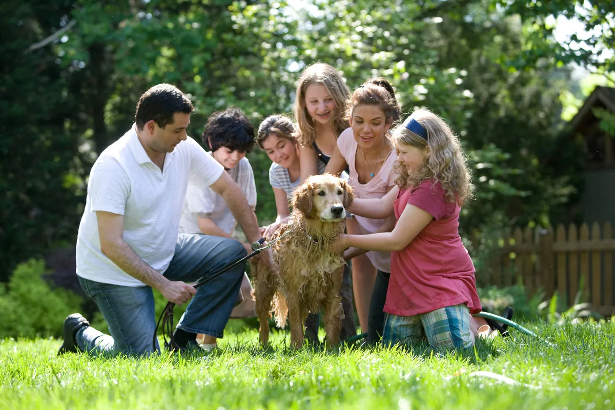 Functionalist Perspectives on the Family, Family and dog in garden, StudySmarter