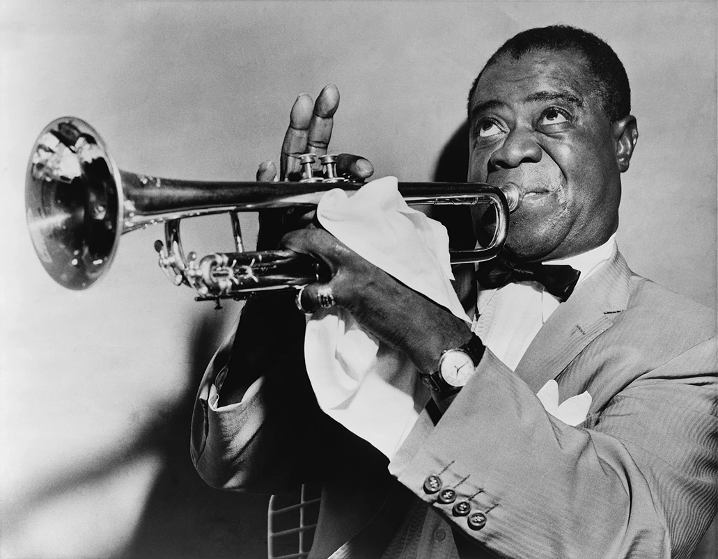 American Pop Culture, Louis Armstrong in a suit playing the trumpet, Study Smarter.