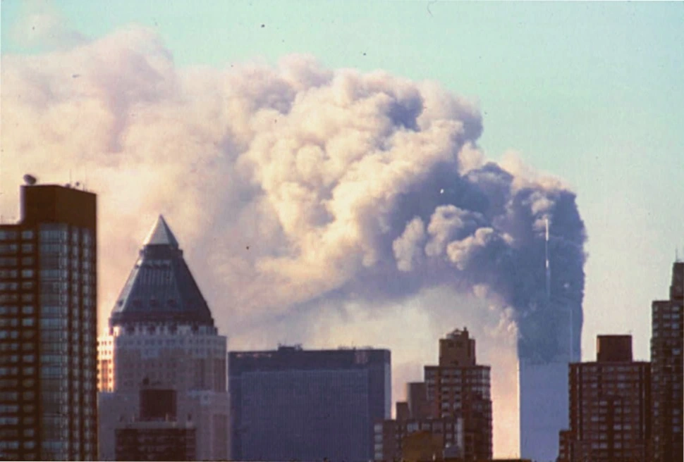The North Tower on fire after a plane crashed into it, by this time the South Tower had already collapsed, Study Smarter