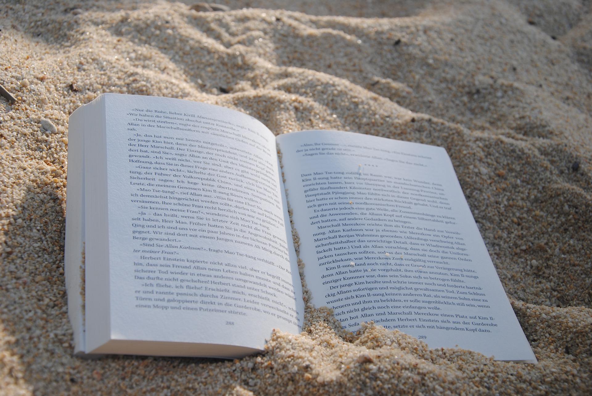 Methodology. A book sinks in the sand. StudySmarter.