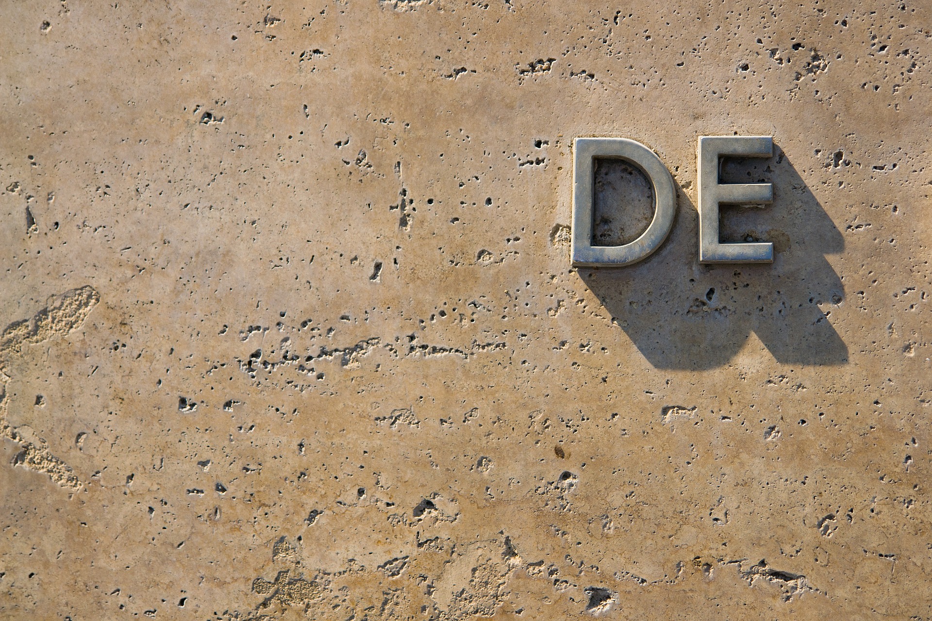 Inference. An incomplete word on stone. StudySmarter.