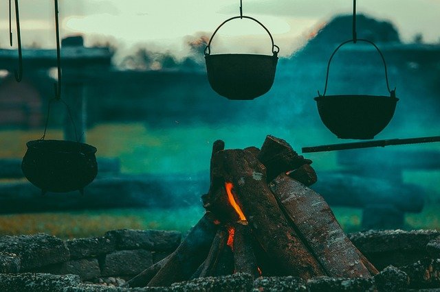 Essays, Image of a cooking pot over a fire, StudySmarter