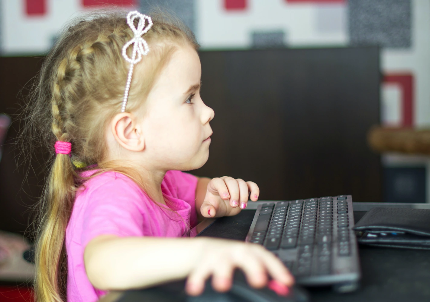 Feminist Theory of Education, A child typing at a computer, StudySmarter