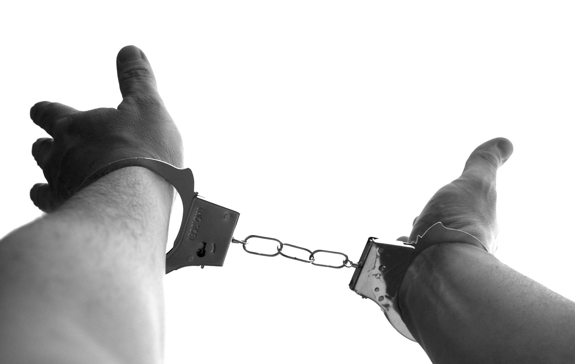 Media Representations and Audiences, image of hands in handcuffs, StudySmarter