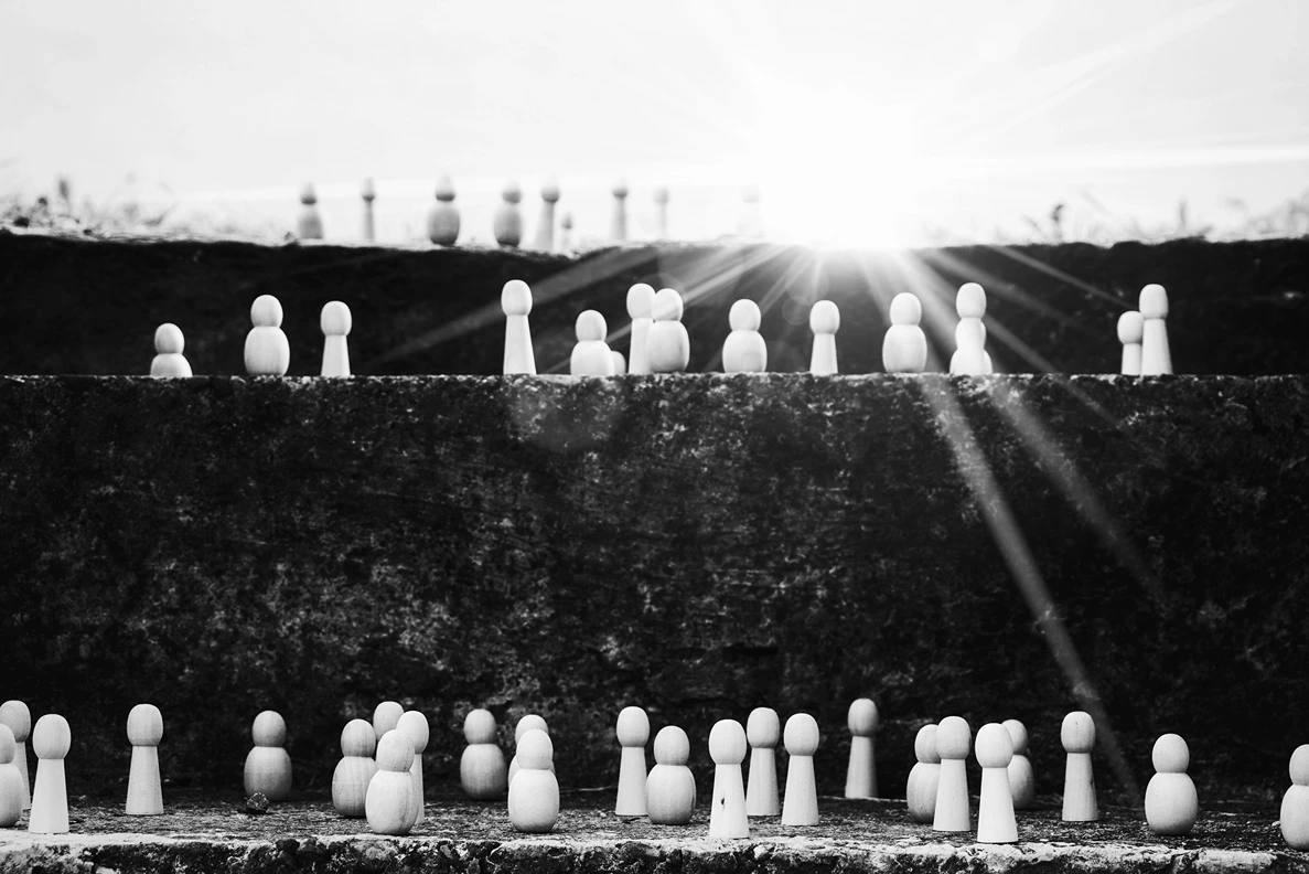 Social Stratification Theories, Chess pieces standing on different levels of ground representing social hierarchy, StudySmarter