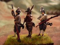 Musketeers loading, front view. The ones with the gray coat are from my second batch, when I tried a base + drybrush technique. Not much better.