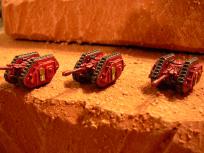 Land Raider Tank Hunters. Streamlined by chopping off the lascannons, serious firepower added by gluing a 28mm lasgun.
Or maybe they are heavy support artillery...