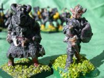 Both are old Citadel. The one on the left was actually sold as 'evil fighter' while the one on the ledt is from the Chaos Marauders box set.