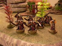 The first squad of Firstborn is done! These are the venerable swordsmen. I decided against the official checkered color scheme and used red with white piping instead.