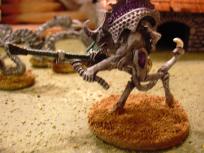 I went for the universal color scheme as with my tyranids, but in retrospect it might have been better to paint the gun in a different color -- it's not really a part of the creature as it is with the 'nids.