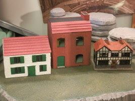 A quick comparison of house sizes. These are all supposed to be two-story houses. On the left there is a Warbases modular house, in the middle Warbases mansard roof house and on the right Dapol's OO scale country inn.