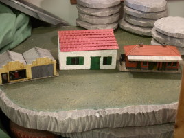 Single story comparison. Dapol's OO scale garage and ticket hall bracket the Warbases modular building.