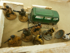 Brave defenders muster -- but they don't know there's a bomb under the Volkswagen!