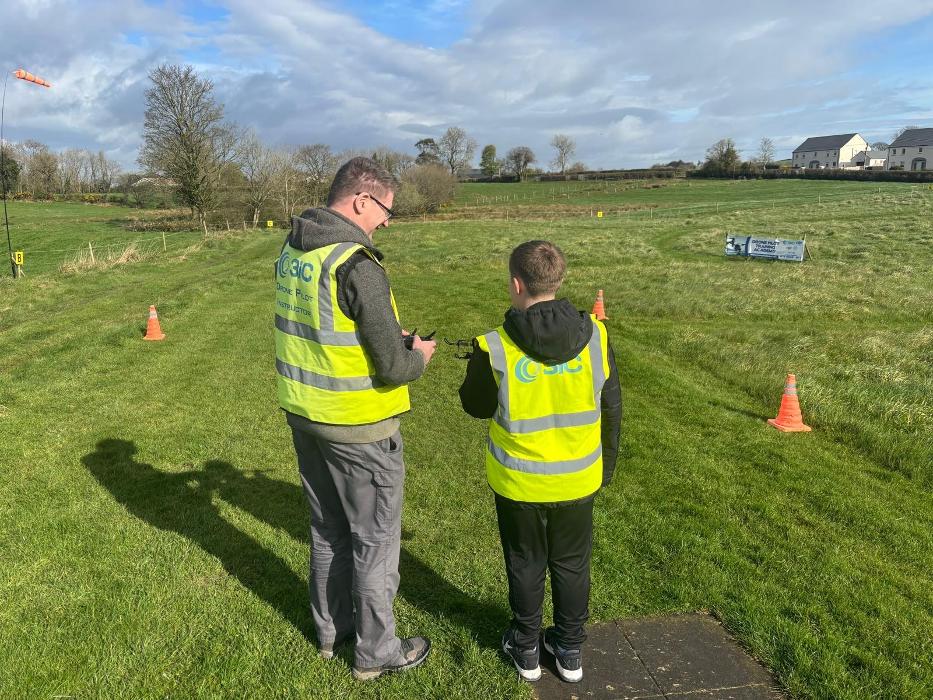 Robert Dobbin 3iC Drone Pilot Instructor with a 11 year Student learning to fly a drone at Drone Pilot Training Academy April 2026