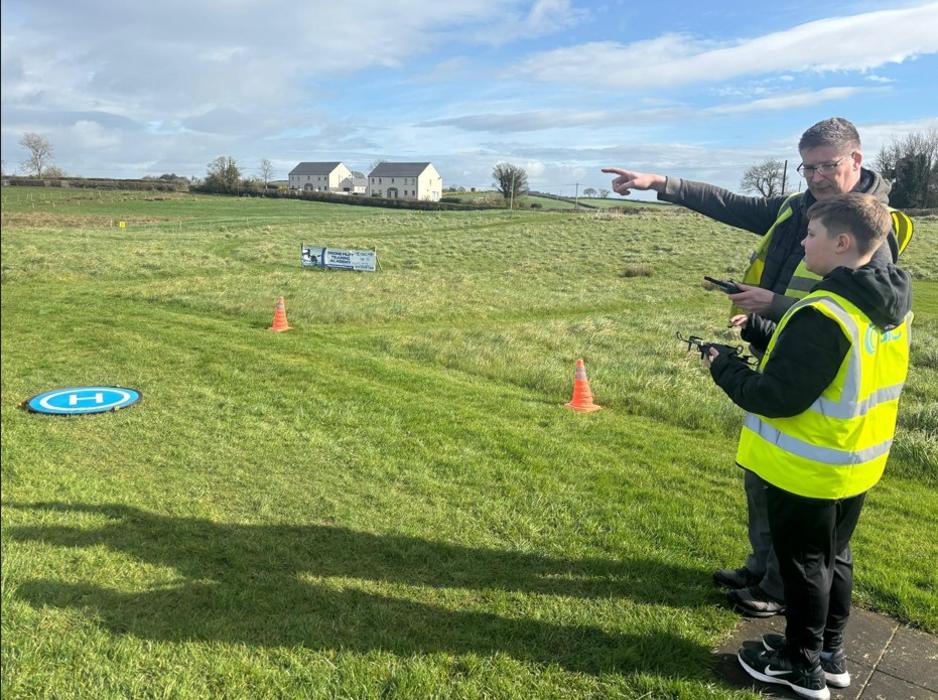 3iC Drone Pilot Instructor Robert Dobbin with a 11 year Student learning to fly a drone at Drone Pilot Training Academy in April 2026
