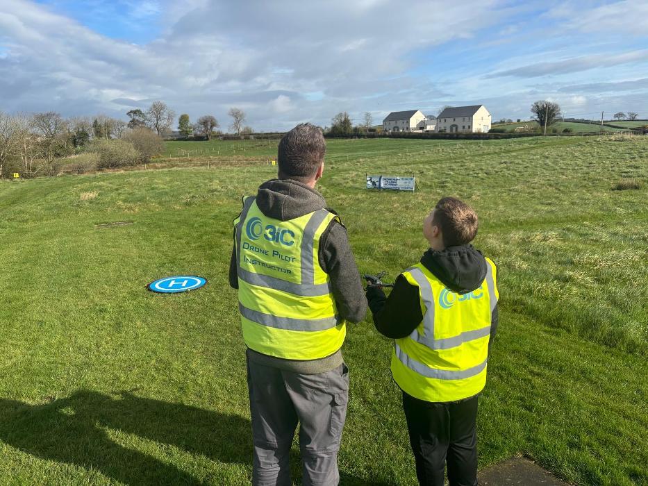Robert Dobbin 3iC Drone Pilot Instructor with a 11 year Student learning to fly a drone at Drone Pilot Training Academy. April 2026