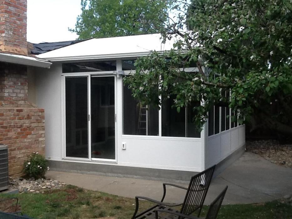 GDM Construction, Four Seasons Sunrooms, exterior view, ConservaGlass patio sliding door, ConservaGlass operable windows, ConservaGlass upper transoms, solid lower transoms