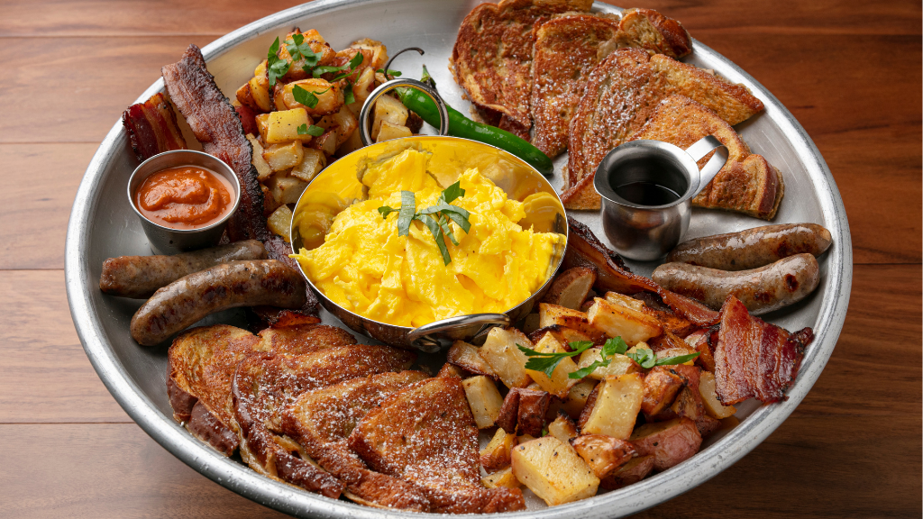 Breakfast Family Style: Dine-in only special with French Toast, scrambled eggs, serrano chile, bacon, sausage, and potatoes.