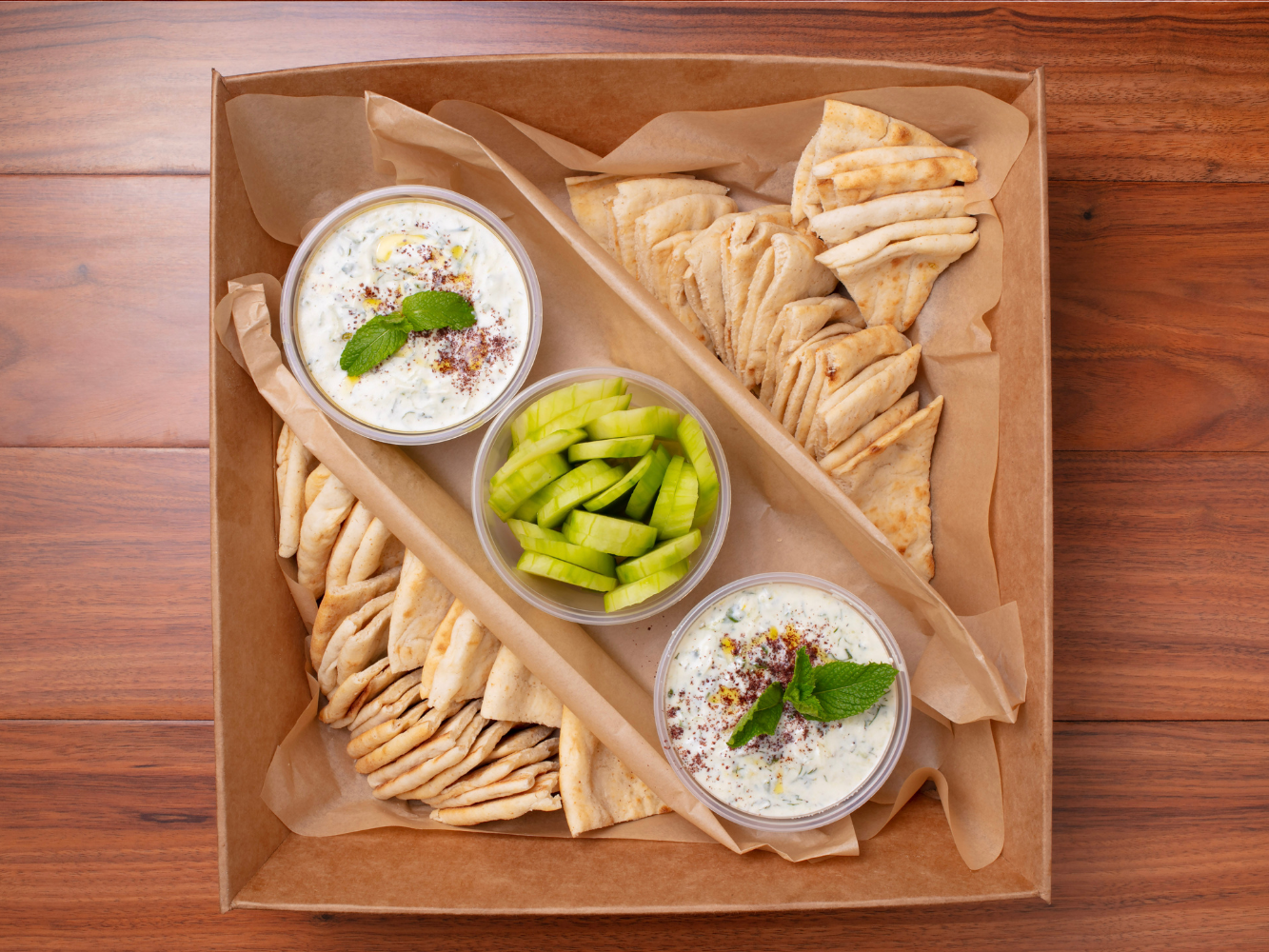 Tzatziki Catering Tray: Tzatziki spread along with pita bread and cucumber slices