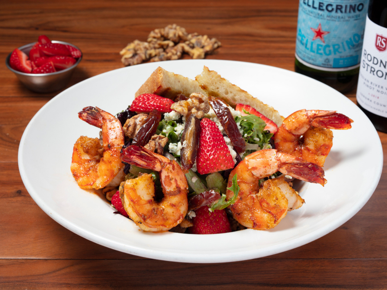 Strawberry Date Salad: Mixed Greens, Strawberries, Candied Walnuts, Medjool Dates, Gorgonzola Cheese and Pomegranate Vinaigrette