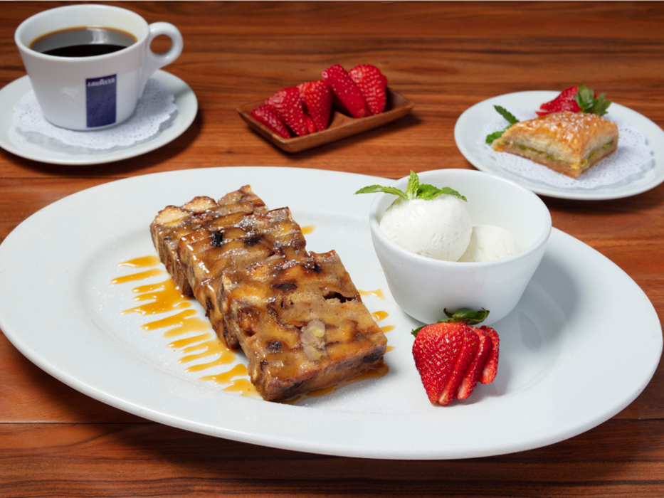 Homemade Banana Bread Pudding with Hawaiian sweet bread, bananas, raisins, dates, and a scoop of vanilla bean ice cream