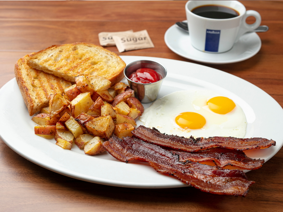 2 Eggs Any Style (Choice of Fresh Berries or Roasted Potatoes. Served w/ Applewood Smoked Bacon).