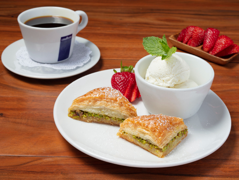 Baklava Plate: Sweet, delicious baklava stuffed with chopped pistachios and served with a scoop of vanilla bean ice cream.