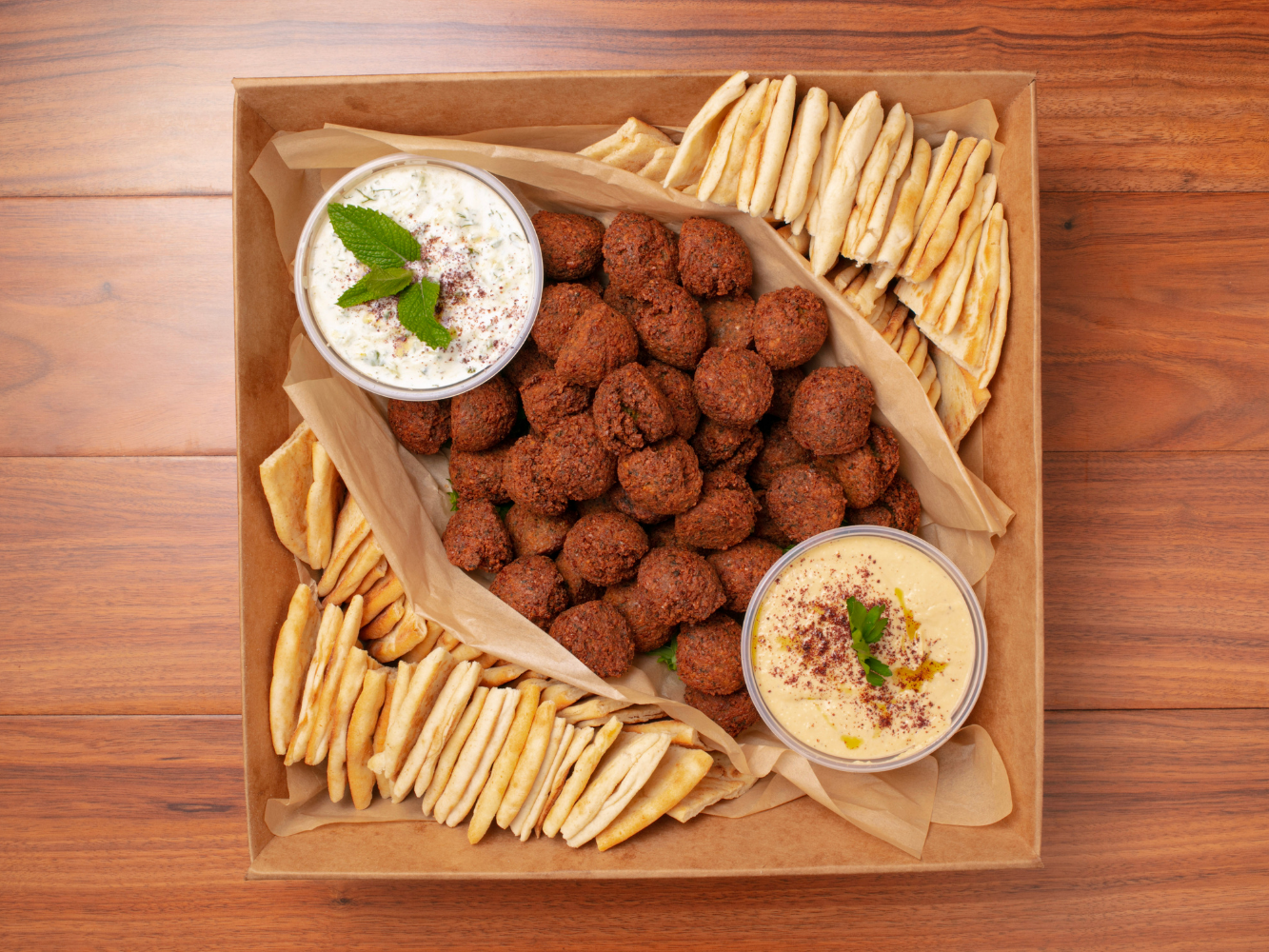 Large Falafel Catering Tray: 50 falafels freshly fried upon order. Hummus and tzatziki included