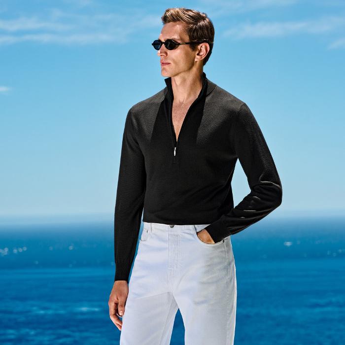 This black half-zip sweater is tailored to a slim fit and features a mock neck collar, lightweight fabric, and long sleeves.