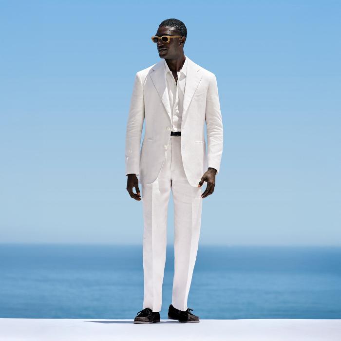 This off-white suit is cut to a relaxed fit with a roomy chest and natural shoulder, featuring a wide notch lapel. Paired with wide-leg straight trousers, offering a single pleat and belt loops.