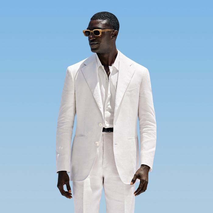 This off-white suit is cut to a relaxed fit with a roomy chest and natural shoulder, featuring a wide notch lapel. Paired with wide-leg straight trousers, offering a single pleat and belt loops.