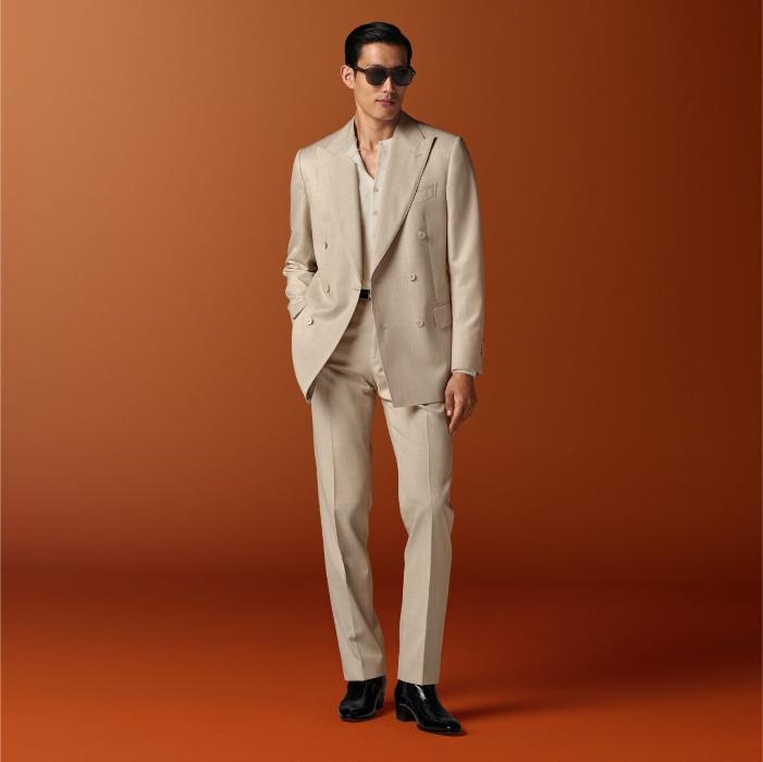 This sand suit is cut to a tailored fit with a padded shoulder, featuring a double-breasted closure. Paired with mid-rise, straight-leg trousers featuring a flat front and belt loops.