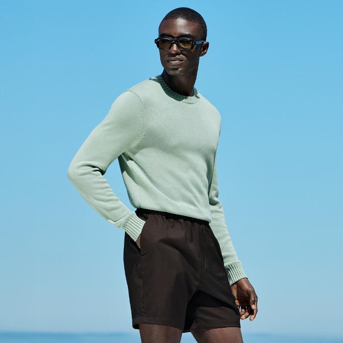 This green crewneck sweater is tailored in a slim fit and features a heavy weight, ribbed hem and cuffs, and a soft texture.