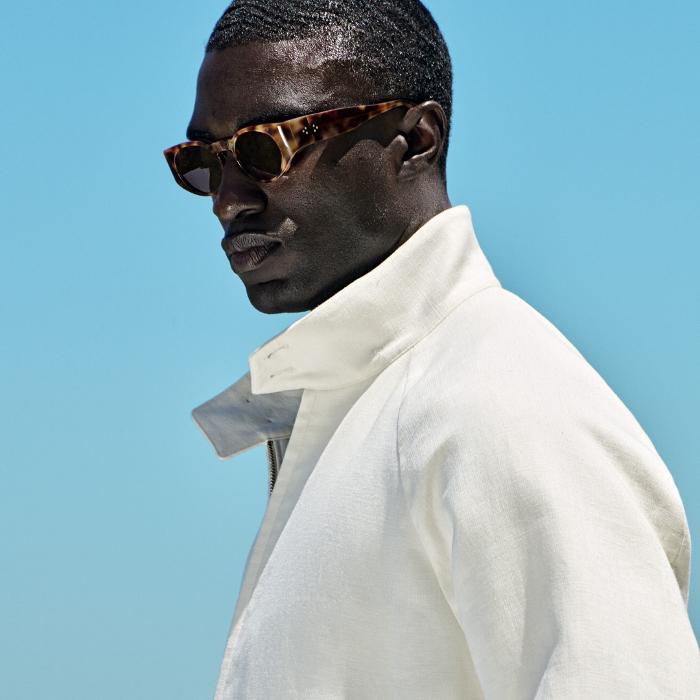 This off-white bomber jacket offers a sleek hip-length cut, high buttoned collar, and raglan shoulders. Features a double-ended zip, flap front pockets, inside pockets, and half-lining for comfort.