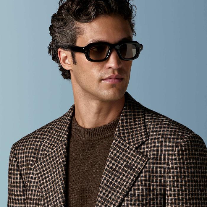 This mid brown checked blazer is cut to a relaxed fit — roomy through the chest and waist with a soft, natural shoulder — and features a notch lapel, patch pockets, and half-canvas construction.