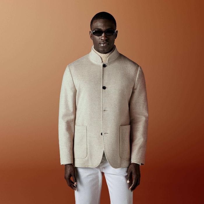 This light brown shirt-jacket is cut to a relaxed fit — easy through the chest and shoulders with a clean, unstructured silhouette — and features a stand collar, patch pockets, and a four-button fastening.