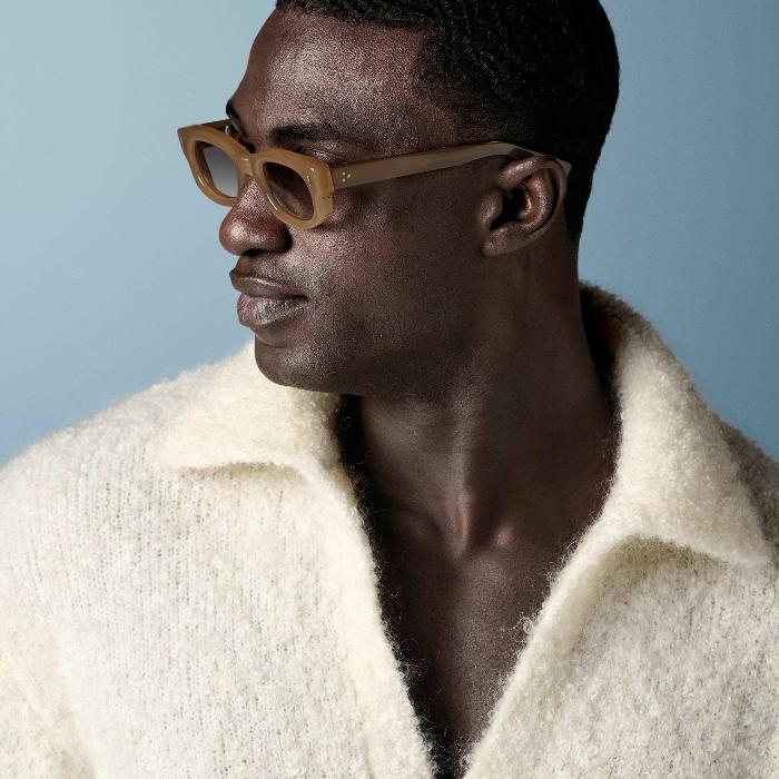 This off-white polo sweater features an open V-neck with a spread collar and no button placket, knitted in a soft, fluffy bouclé texture with long sleeves and a relaxed silhouette.