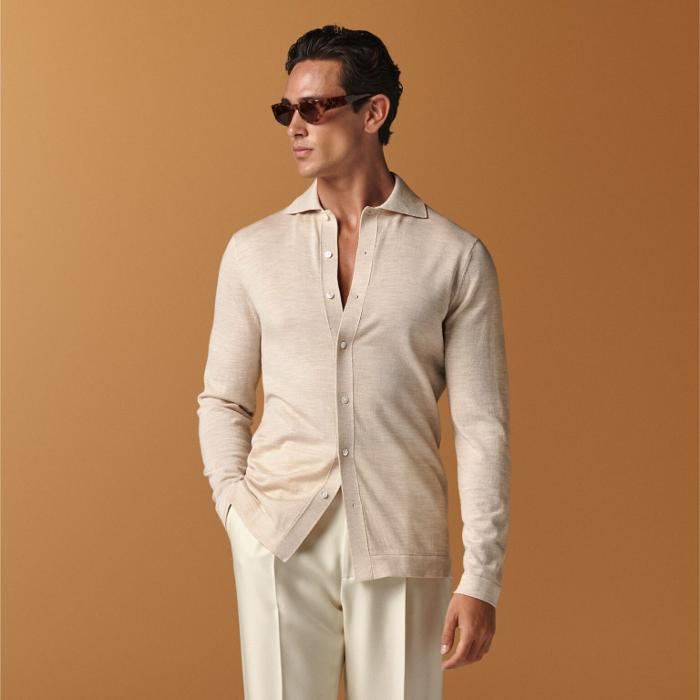 This sand long-sleeve polo cardigan is tailored in a slim fit and features a polo collar, full placket with a 7-button closure, and lightweight fabric for stylish, comfortable wear.