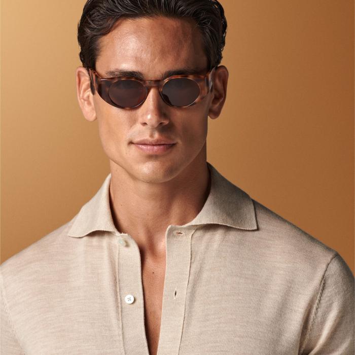 This sand long-sleeve polo cardigan is tailored in a slim fit and features a polo collar, full placket with a 7-button closure, and lightweight fabric for stylish, comfortable wear.